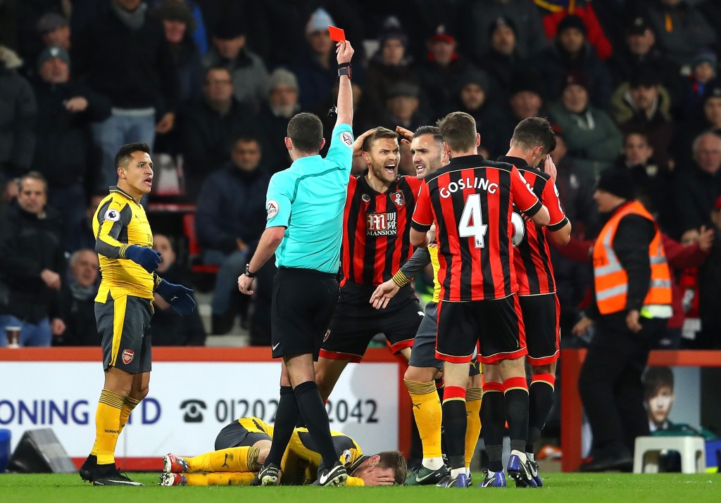 BOURNEMOUTH, ENGLAND - JANUARY 03: Simon Francis (4th R) of AFC Bournemouth reacts after receiving a red card by referee Michael Oliver (2nd L) after tackling on Aaron Ramsey of Arsenal during the Premier League match between AFC Bournemouth and Arsenal at Vitality Stadium on January 3, 2017 in Bournemouth, England. (Photo by Warren Little/Getty Images)