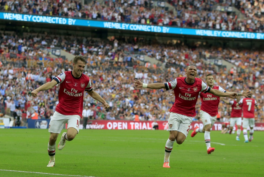 Arsenal's Welsh midfielder Aaron Ramsey (L) celebrates scoring his team's third and winning goal with Arsenal's English defender Kieran Gibbs during the English FA Cup final match between Arsenal and Hull City at Wembly Stadium in London on May 17, 2014. AFP PHOTO/ADRIAN DENNIS NOT FOR MARKETING OR ADVERTISING USE / RESTRICTED TO EDITORIAL USE (Photo credit should read ADRIAN DENNIS,ADRIAN DENNIS/AFP/Getty Images)