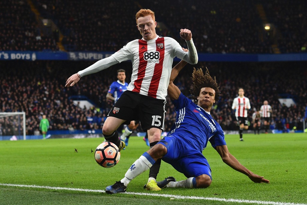 Chelsea's Dutch defender Nathan Ake (R) tackles Brentford's English midfielder Ryan Woods (L) during the English FA Cup fourth round football match between Chelsea and Brentford at Stamford Bridge in London on January 28, 2017. / AFP / Glyn KIRK / RESTRICTED TO EDITORIAL USE. No use with unauthorized audio, video, data, fixture lists, club/league logos or 'live' services. Online in-match use limited to 75 images, no video emulation. No use in betting, games or single club/league/player publications. / (Photo credit should read GLYN KIRK/AFP/Getty Images)