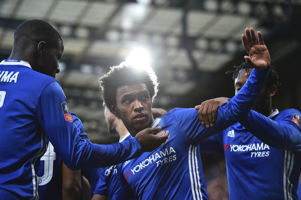 Chelsea's Brazilian midfielder Willian (C) celebrates scoring the opening goal during the English FA Cup fourth round football match between Chelsea and Brentford at Stamford Bridge in London on January 28, 2017. / AFP / Glyn KIRK / RESTRICTED TO EDITORIAL USE. No use with unauthorized audio, video, data, fixture lists, club/league logos or 'live' services. Online in-match use limited to 75 images, no video emulation. No use in betting, games or single club/league/player publications. / (Photo credit should read GLYN KIRK/AFP/Getty Images)