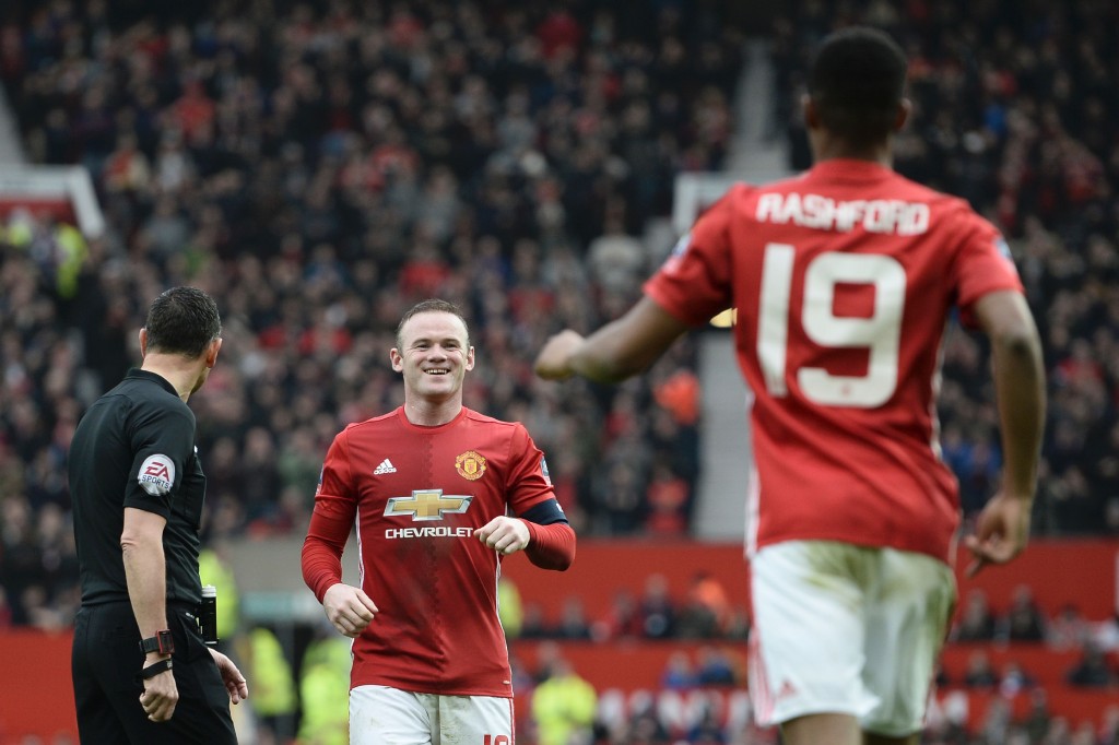 Manchester United's English striker Wayne Rooney (C) celebrates with Manchester United's English striker Marcus Rashford (R) after Rashford scored their third goal during the English FA Cup third round football match between Manchester United and Reading at Old Trafford in Manchester, north west England, on January 7, 2017. / AFP / Oli SCARFF / RESTRICTED TO EDITORIAL USE. No use with unauthorized audio, video, data, fixture lists, club/league logos or 'live' services. Online in-match use limited to 75 images, no video emulation. No use in betting, games or single club/league/player publications. / (Photo credit should read OLI SCARFF/AFP/Getty Images)