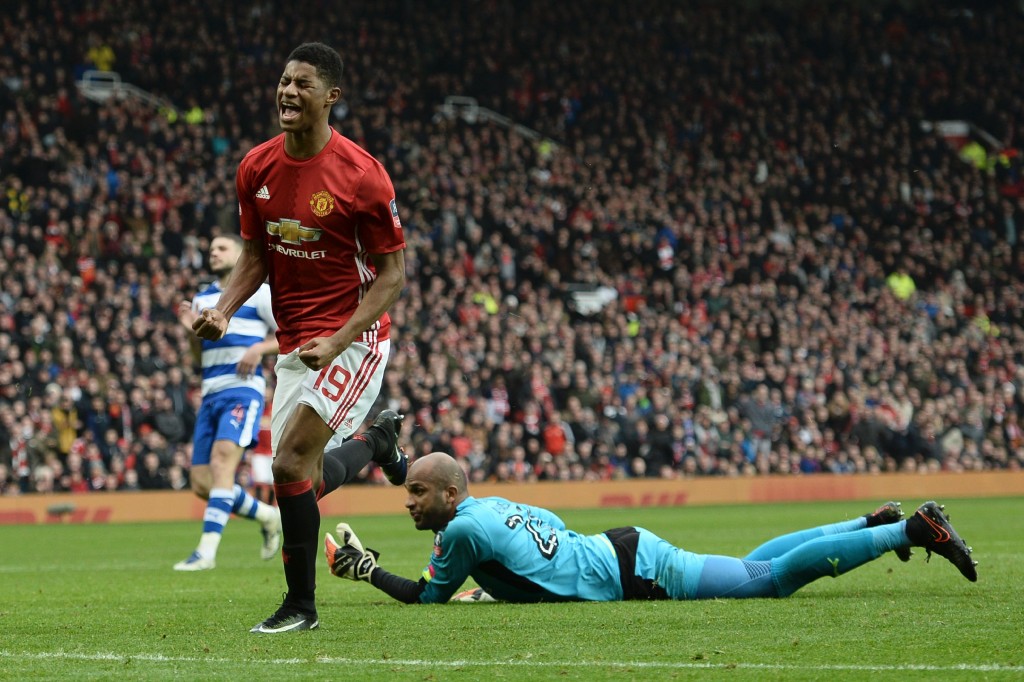 Manchester United's English striker Marcus Rashford (L) celebrates scoreing their third goal during the English FA Cup third round football match between Manchester United and Reading at Old Trafford in Manchester, north west England, on January 7, 2017. / AFP / Oli SCARFF / RESTRICTED TO EDITORIAL USE. No use with unauthorized audio, video, data, fixture lists, club/league logos or 'live' services. Online in-match use limited to 75 images, no video emulation. No use in betting, games or single club/league/player publications. / (Photo credit should read OLI SCARFF/AFP/Getty Images)