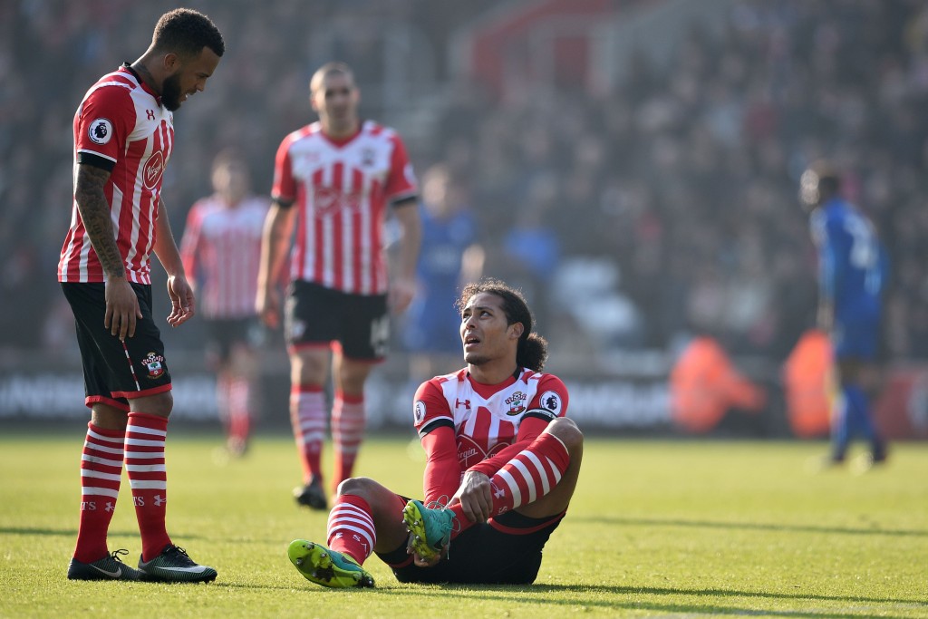 Southampton's Dutch defender Virgil van Dijk (C) sits down injured as Southampton's English defender Ryan Bertrand (L) looks on during the English Premier League football match between Southampton and Leicester City at St Mary's Stadium in Southampton, southern England on January 22, 2017. / AFP / Glyn KIRK / RESTRICTED TO EDITORIAL USE. No use with unauthorized audio, video, data, fixture lists, club/league logos or 'live' services. Online in-match use limited to 75 images, no video emulation. No use in betting, games or single club/league/player publications. / (Photo credit should read GLYN KIRK/AFP/Getty Images)