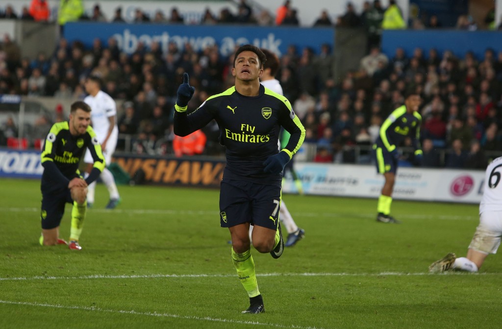 Arsenal's Chilean striker Alexis Sanchez celebrates scoring his team's fourth goal during the English Premier League football match between Swansea City and Arsenal at The Liberty Stadium in Swansea, south Wales on January 14, 2017. / AFP / Geoff CADDICK / RESTRICTED TO EDITORIAL USE. No use with unauthorized audio, video, data, fixture lists, club/league logos or 'live' services. Online in-match use limited to 75 images, no video emulation. No use in betting, games or single club/league/player publications. / (Photo credit should read GEOFF CADDICK/AFP/Getty Images)