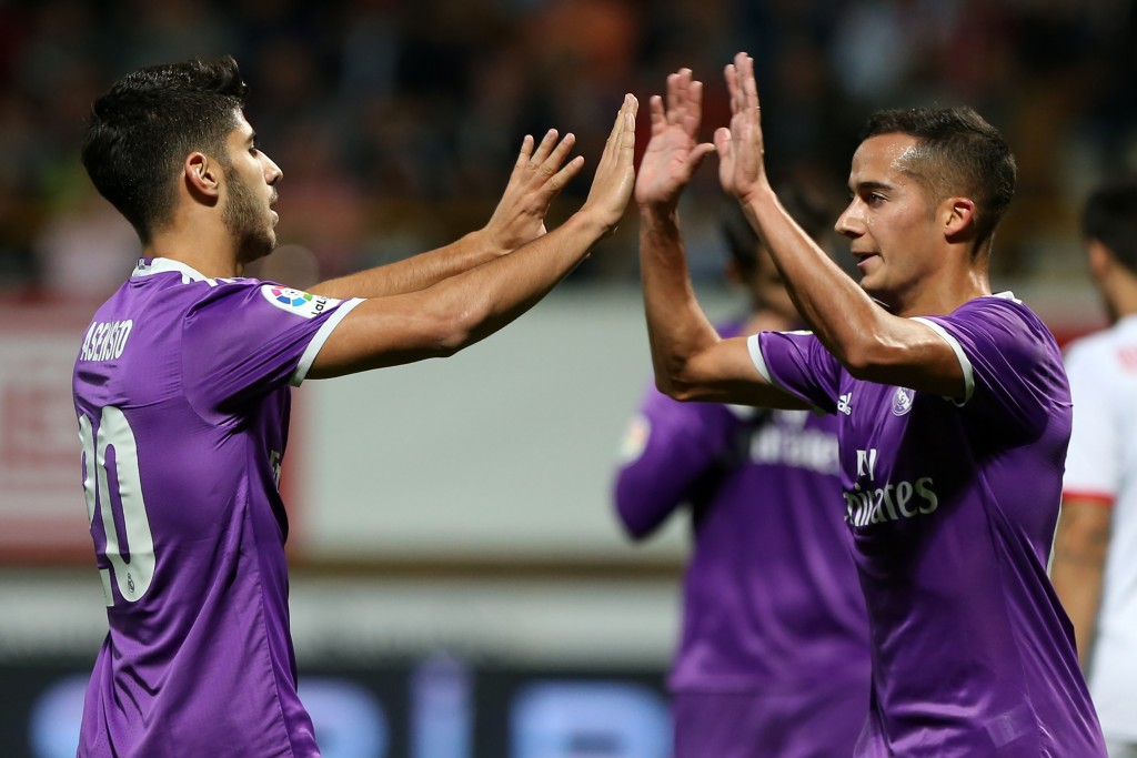 Real Madrid's midfielder Marco Asensio (L) celebrates a goal with Real Madrid's midfielder Lucas Vazquez during the Spanish Copa del Rey (King's Cup) round of 32 first leg football match between Cultural y Deportiva Leonesa and Real Madrid at the Reino de Leon stadium in Leon, on October 26, 2016. / AFP / CESAR MANSO (Photo credit should read CESAR MANSO/AFP/Getty Images)