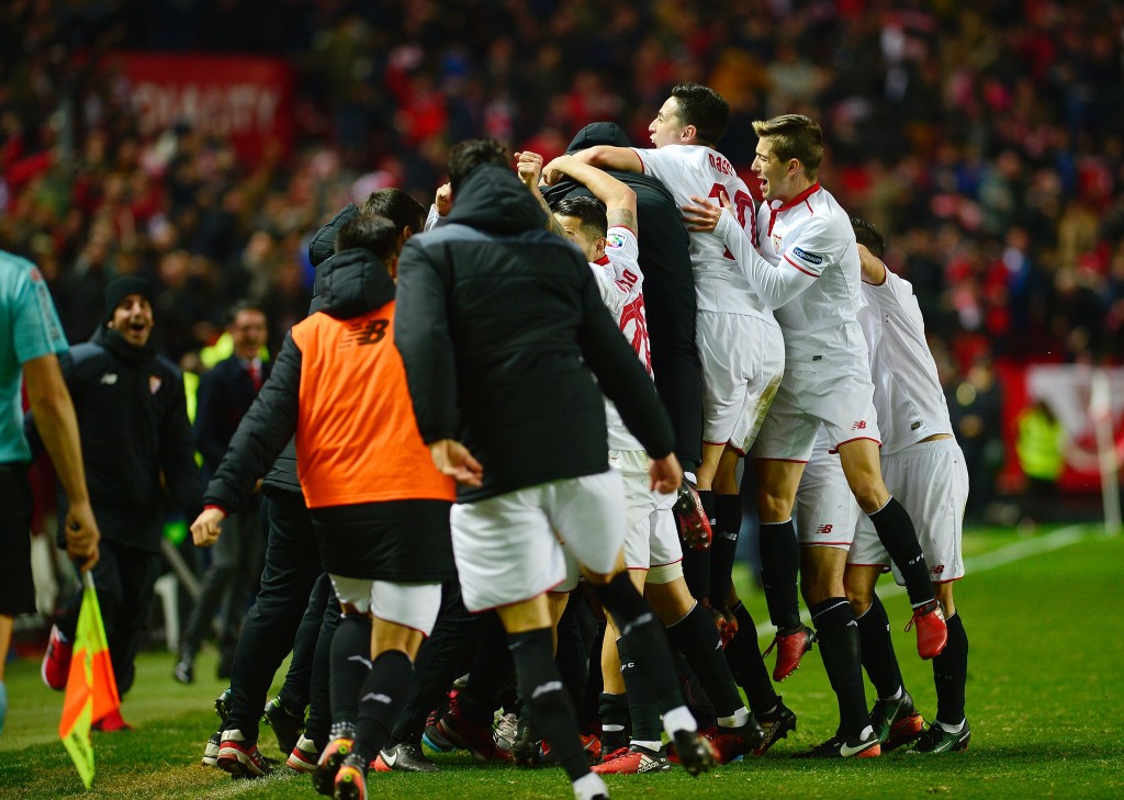 Sevilla's players celebrate after scoring their 2-1 victory goal during the Spanish league football match Sevilla FC vs Real Madrid CF at the Ramon Sanchez Pizjuan stadium in Sevilla on January 15, 2017. Sevilla won 2-1. (Photo courtesy - Cristina Quicler/AFP/Getty Images)