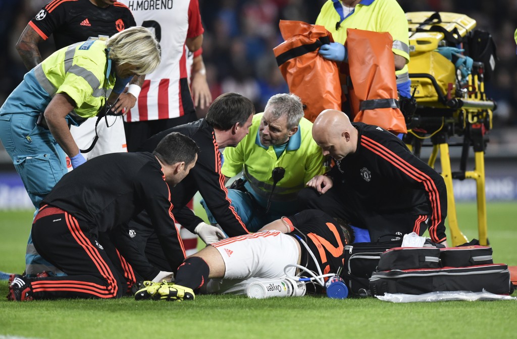 Manchester's defender Luke Shaw receives treatment for a double fracture of the leg during the UEFA Champions League Group B football match between PSV Eindhoven and Manchester United at the Philips stadium in Eindhoven, the Netherlands on September 15, 2015. PSV Eindhoven defeated Manchester 2-1. AFP PHOTO / JOHN THYS (Photo credit should read JOHN THYS/AFP/Getty Images)