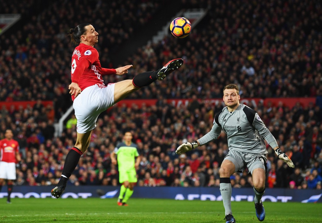 MANCHESTER, ENGLAND - JANUARY 15: Zlatan Ibrahimovic of Manchester United stretches for the ball as Simon Mignolet of Liverpool looks on during the Premier League match between Manchester United and Liverpool at Old Trafford on January 15, 2017 in Manchester, England. (Photo by Laurence Griffiths/Getty Images)