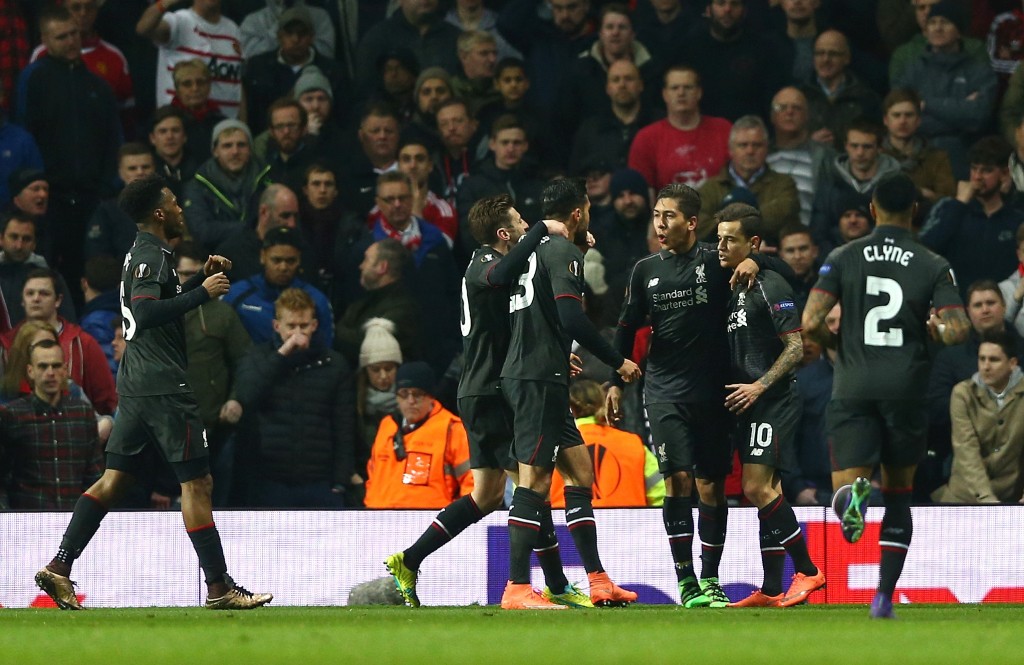 MANCHESTER, ENGLAND - MARCH 17: Philippe Coutinho of Liverpool (10) celebrates with team mates as he scores their first goal during the UEFA Europa League round of 16, second leg match between Manchester United and Liverpool at Old Trafford on March 17, 2016 in Manchester, England. (Photo by Clive Brunskill/Getty Images)