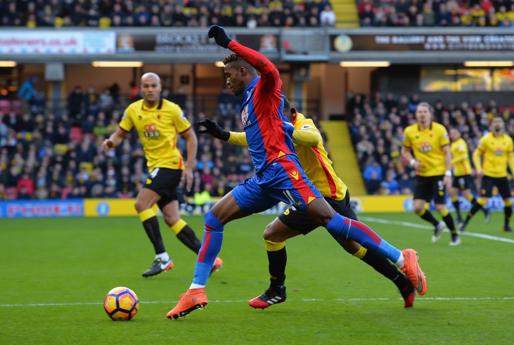 WATFORD, ENGLAND - DECEMBER 26: Camilo Zuniga of Watford tackles Wilfried Zaha of Crystal Palace during the Barclays Premier League match between Watford and Crystal Palace at Vicarage Road on December 26, 2016 in Watford, England. (Photo by Tony Marshall/Getty Images)