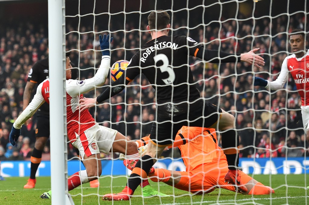 Arsenal's Chilean striker Alexis Sanchez (L) scores the opening goal of the English Premier League football match between Arsenal and Hull City at the Emirates Stadium in London on February 11, 2017. / AFP / Glyn KIRK / RESTRICTED TO EDITORIAL USE. No use with unauthorized audio, video, data, fixture lists, club/league logos or 'live' services. Online in-match use limited to 75 images, no video emulation. No use in betting, games or single club/league/player publications. / (Photo credit should read GLYN KIRK/AFP/Getty Images)