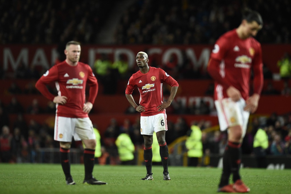 Manchester United's English striker Wayne Rooney (L) Manchester United's French midfielder Paul Pogba and Manchester United's Swedish striker Zlatan Ibrahimovic react following the English Premier League football match between Manchester United and Hull City at Old Trafford in Manchester, north west England, on February 1, 2017. The match ended in a draw at 0-0. / AFP / Oli SCARFF / RESTRICTED TO EDITORIAL USE. No use with unauthorized audio, video, data, fixture lists, club/league logos or 'live' services. Online in-match use limited to 75 images, no video emulation. No use in betting, games or single club/league/player publications. / (Photo credit should read OLI SCARFF/AFP/Getty Images)