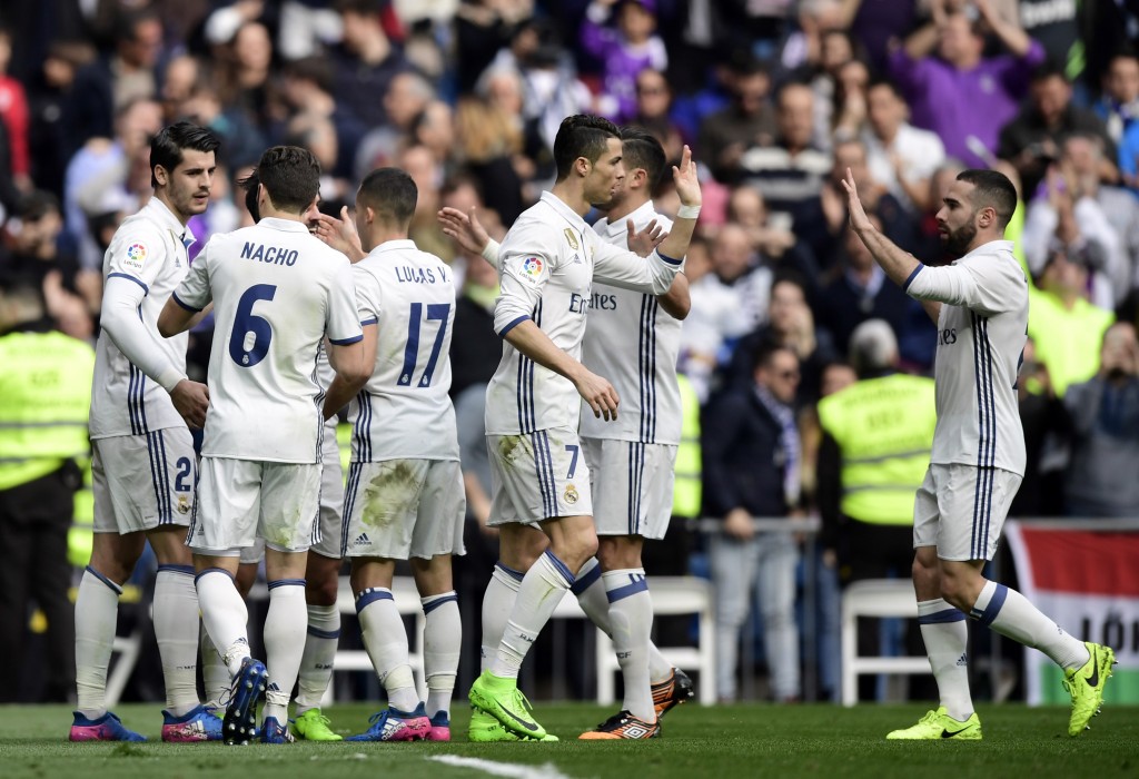 Real Madrid players celebrate a goal during the Spanish league football match Real Madrid CF vs RCD Espanyol at the Santiago Bernabeu stadium in Madrid on February 18, 2017. / AFP / JAVIER SORIANO (Photo credit should read JAVIER SORIANO/AFP/Getty Images)
