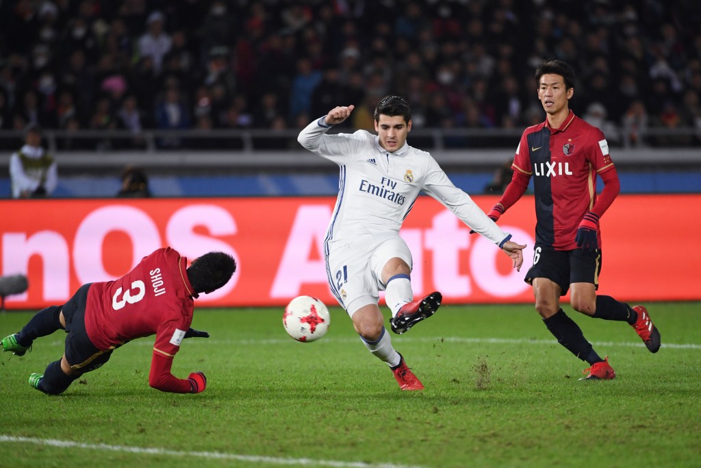 Real Madrid forward Alvaro Morata (C) shoots past Kashima Antlers defender Gen Shoji (L) during the Club World Cup football final match between Kashima Antlers of Japan and Real Madrid of Spain at Yokohama International stadium in Yokohama on December 18, 2016. / AFP / Toshifumi KITAMURA (Photo credit should read TOSHIFUMI KITAMURA/AFP/Getty Images)