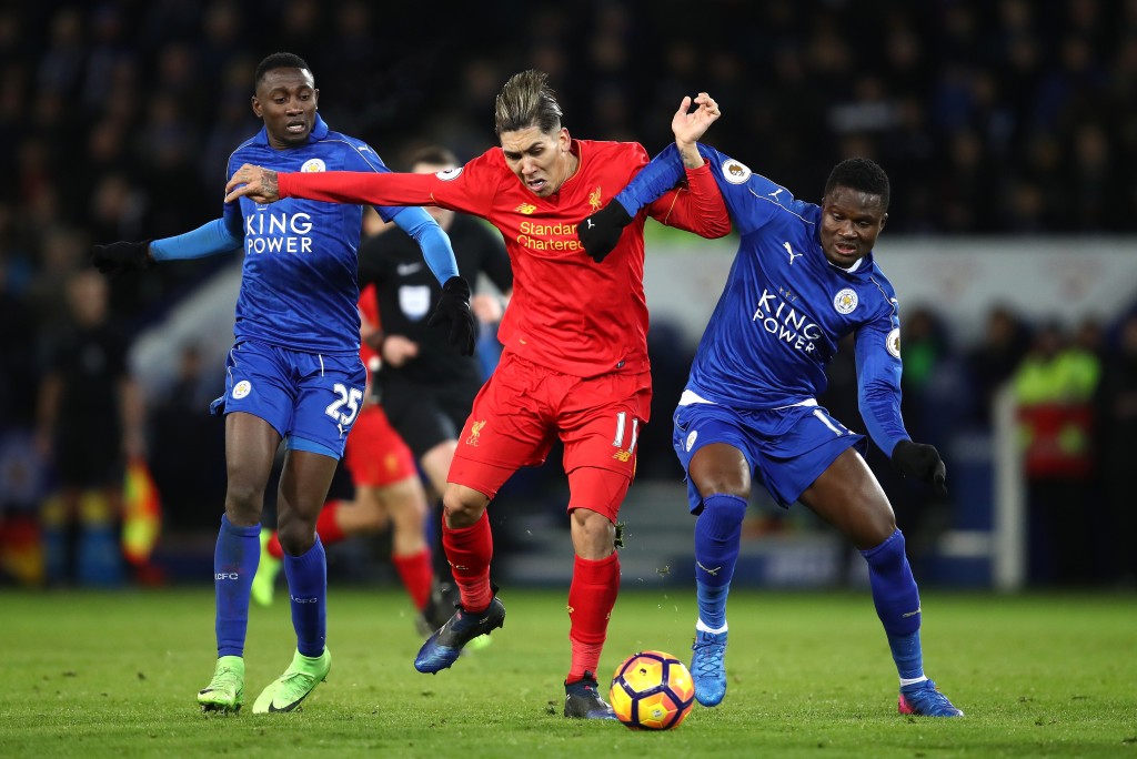LEICESTER, ENGLAND - FEBRUARY 27: Roberto Firmino of Liverpool holds off Daniel Amartey of Leicester City (R) and Wilfred Ndidi of Liecester City (L)during the Premier League match between Leicester City and Liverpool at The King Power Stadium on February 27, 2017 in Leicester, England. (Photo by Julian Finney/Getty Images)
