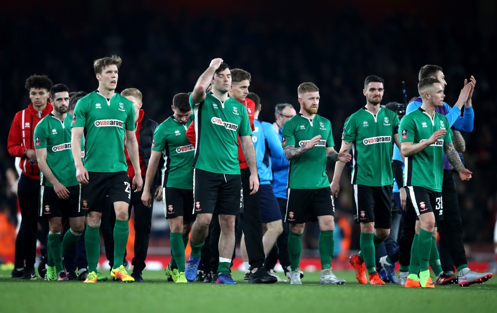 LONDON, ENGLAND - MARCH 11: Lincoln City players applaud supporters after the full time whistle following defeat in The Emirates FA Cup Quarter-Final match between Arsenal and Lincoln City at Emirates Stadium on March 11, 2017 in London, England. (Photo by Julian Finney/Getty Images)