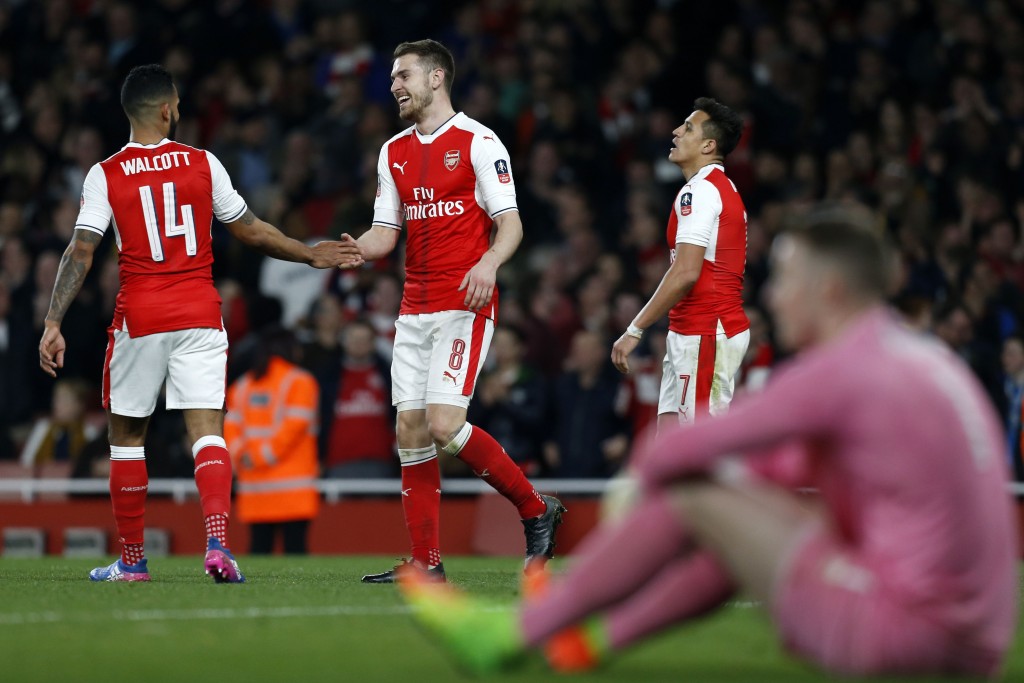 Arsenal's Welsh midfielder Aaron Ramsey (2nd L) celebrates with Arsenal's English midfielder Theo Walcott (L) after scoring their fifth goal during the English FA cup quarter final football match between Arsenal and Lincoln City at The Emirates Stadium in London on March 11, 2017. / AFP PHOTO / Ian KINGTON / RESTRICTED TO EDITORIAL USE. No use with unauthorized audio, video, data, fixture lists, club/league logos or 'live' services. Online in-match use limited to 75 images, no video emulation. No use in betting, games or single club/league/player publications. / (Photo credit should read IAN KINGTON/AFP/Getty Images)