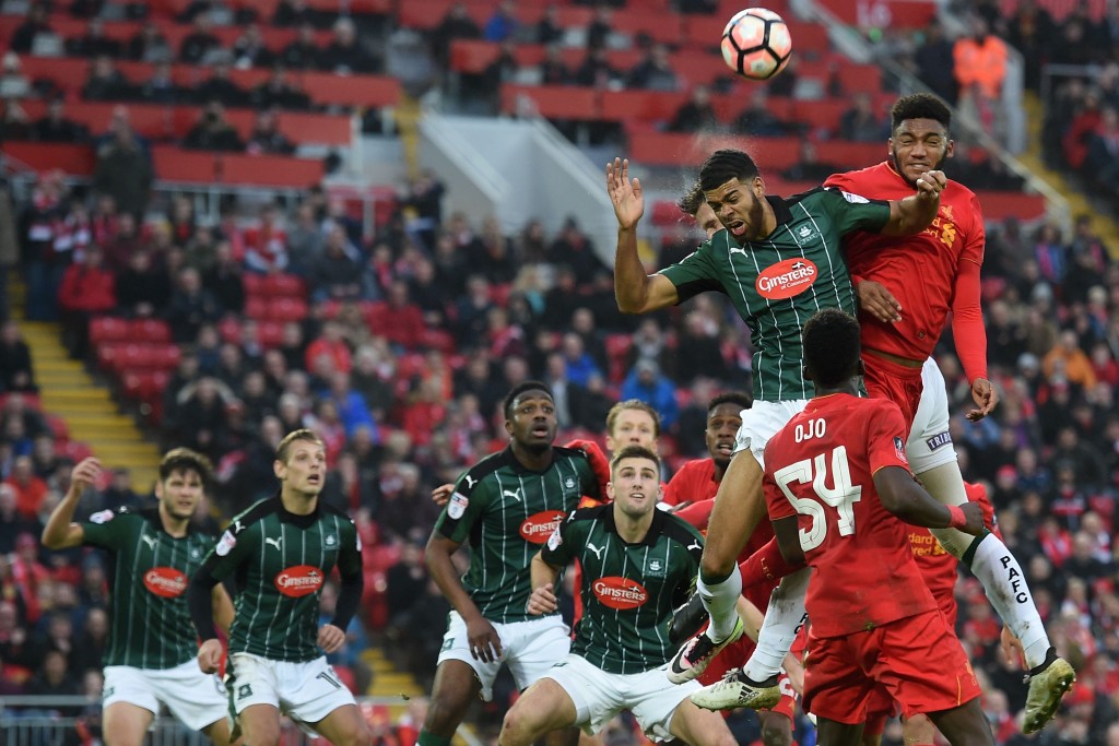 Liverpool's English defender Joe Gomez (R) jumps against Plymouth's English striker Jake Jervis to head the ball during the English FA Cup third round football match between Liverpool and Plymouth Argyle at Anfield in Liverpool, north west England on January 8, 2017. The game finished 0-0. / AFP / Paul ELLIS / RESTRICTED TO EDITORIAL USE. No use with unauthorized audio, video, data, fixture lists, club/league logos or 'live' services. Online in-match use limited to 75 images, no video emulation. No use in betting, games or single club/league/player publications. / (Photo credit should read PAUL ELLIS/AFP/Getty Images)