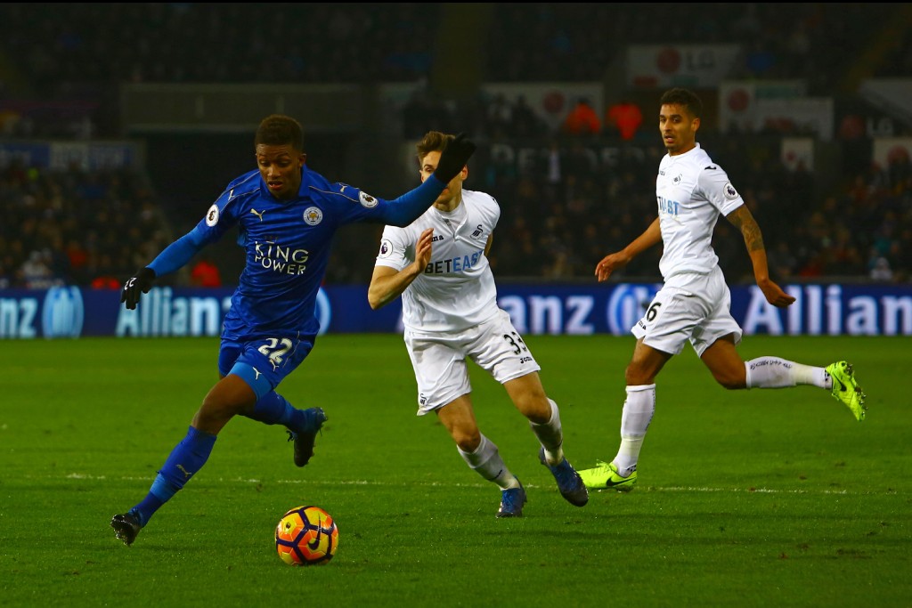 Leicester City's English midfielder Demarai Gray (L) runs with the ball during the English Premier League football match between Swansea City and Leicester City at The Liberty Stadium in Swansea, south Wales on February 12, 2017. / AFP / Geoff CADDICK / RESTRICTED TO EDITORIAL USE. No use with unauthorized audio, video, data, fixture lists, club/league logos or 'live' services. Online in-match use limited to 75 images, no video emulation. No use in betting, games or single club/league/player publications. / (Photo credit should read GEOFF CADDICK/AFP/Getty Images)