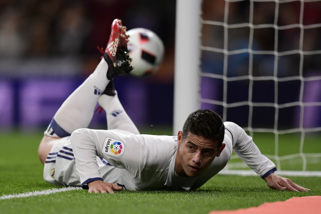 Real Madrid's Colombian midfielder James Rodriguez lies on the ground as he celebrates after scoring during the Spanish Copa del Rey (King's Cup) Round of 32 second leg football match Real Madrid CF vs Cultural y Deportiva Leonesa at the Santiago Bernabeu stadium in Madrid on November 30, 2016. / AFP / JAVIER SORIANO (Photo credit should read JAVIER SORIANO/AFP/Getty Images)