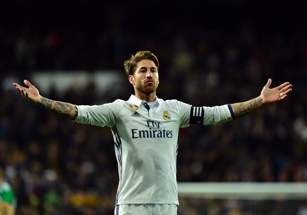Real Madrid's defender Sergio Ramos celebrates after scoring a goal during the Spanish league footbal match Real Madrid CF vs Real Betis at the Santiago Bernabeu stadium in Madrid on March 12, 2017. / AFP PHOTO / GERARD JULIEN (Photo credit should read GERARD JULIEN/AFP/Getty Images)