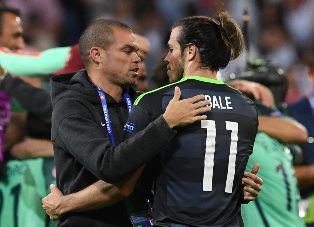 Portugal's defender Pepe (L) comforts Wales' forward Gareth Bale at the end of the Euro 2016 semi-final football match between Portugal and Wales at the Parc Olympique Lyonnais stadium in Décines-Charpieu, near Lyon, on July 6, 2016. / AFP / Francisco LEONG (Photo credit should read FRANCISCO LEONG/AFP/Getty Images)
