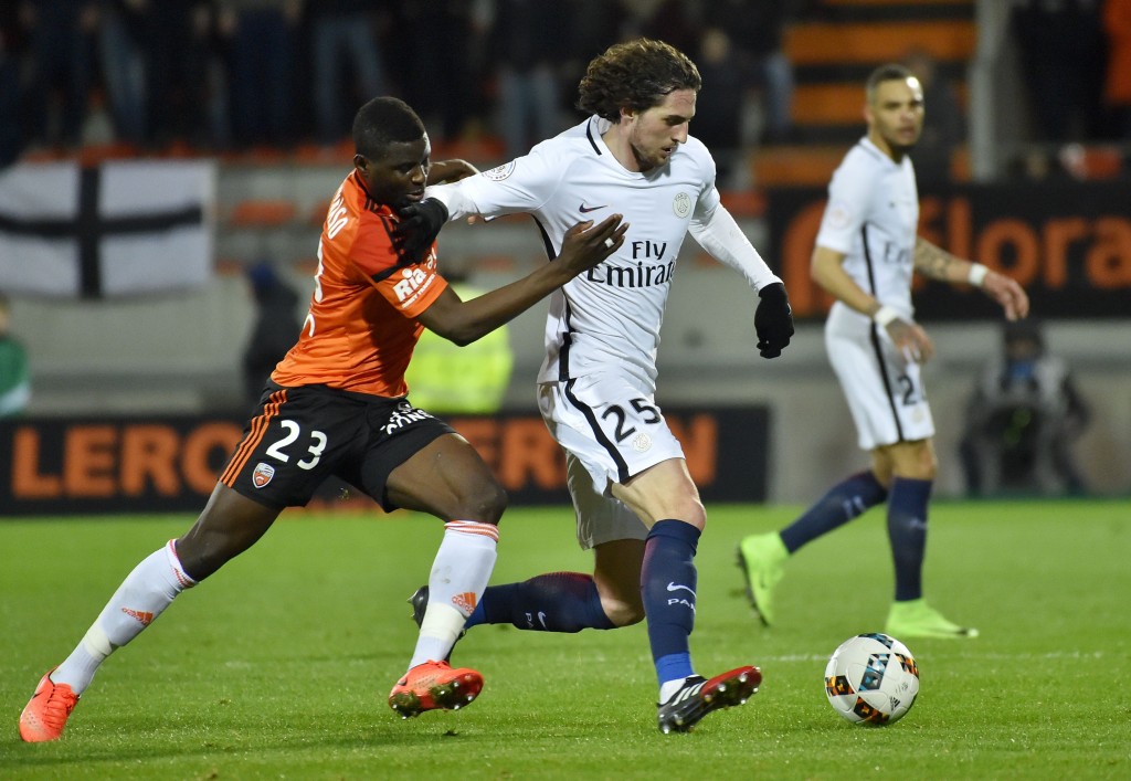 Lorient's defender Alhassan Wakaso (L) vies with Paris Saint-Germain's French midfielder Adrien Rabiot during the French L1 football match Lorient vs Paris SG at the Moustoir stadium in Lorient on March 12, 2017. / AFP PHOTO / LOIC VENANCE (Photo credit should read LOIC VENANCE/AFP/Getty Images)