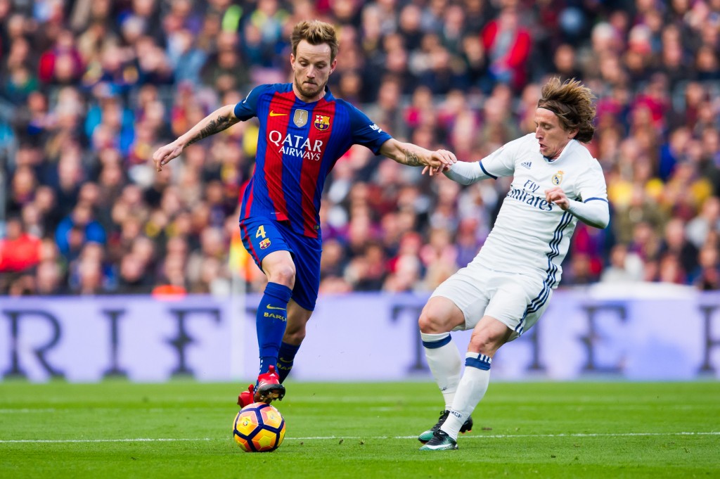 BARCELONA, SPAIN - DECEMBER 03: Ivan Rakitic (L) of FC Barcelona fights for the ball with Luka Modric (R) of Real Madrid CF during the La Liga match between FC Barcelona and Real Madrid CF at Camp Nou stadium on December 3, 2016 in Barcelona, Spain. (Photo courtesy - Alex Caparros/Getty Images)