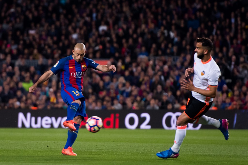 BARCELONA, SPAIN - MARCH 19: Javier Mascherano (L) of FC Barcelona shoots on goal next to Martin Montoya of Valencia CF during the La Liga match between FC Barcelona and Valencia CF at Camp Nou stadium on March 19, 2017 in Barcelona, Spain. (Photo by Alex Caparros/Getty Images)