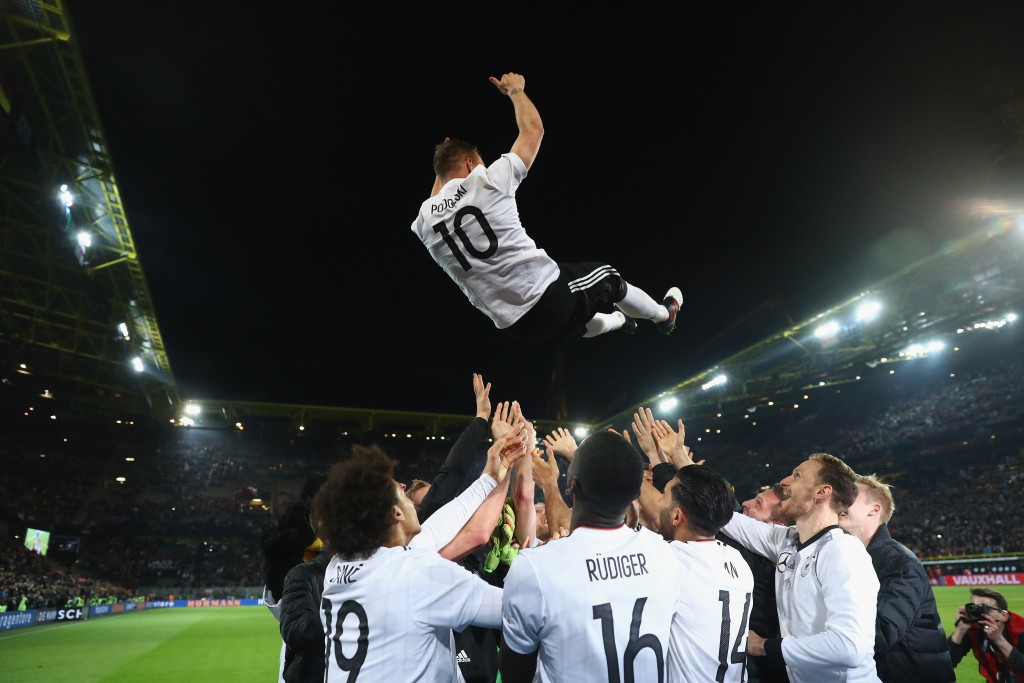 DORTMUND, GERMANY - MARCH 22: Lukas Podolski is thrown in the air by his team mates after playing his last game for Germany during the international friendly match between Germany and England at Signal Iduna Park on March 22, 2017 in Dortmund, Germany. (Photo by Alex Grimm/Bongarts/Getty Images)