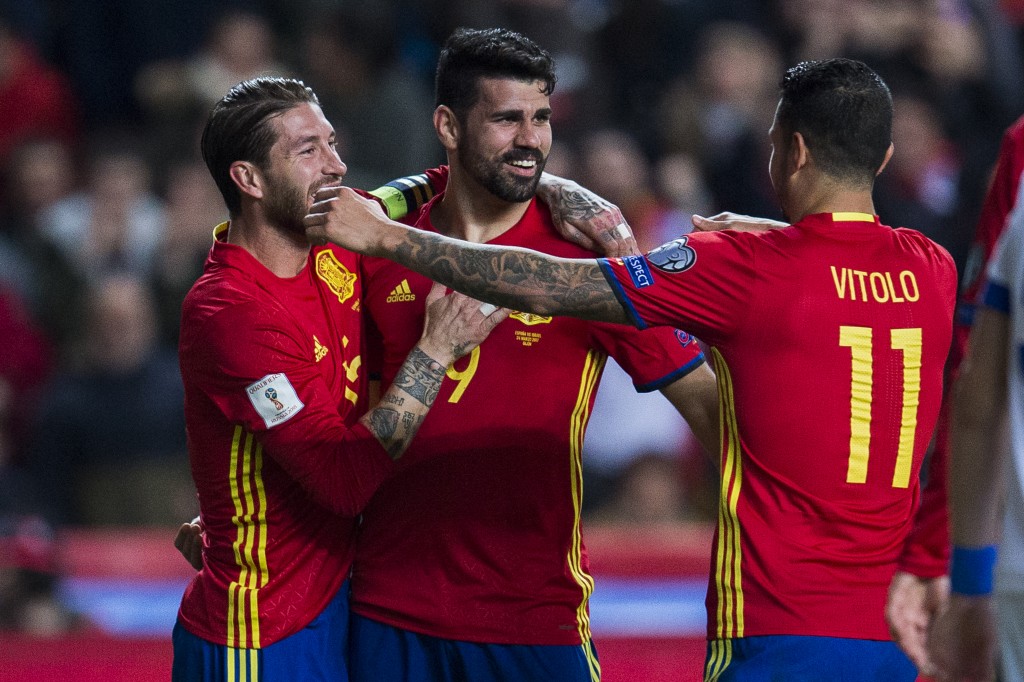 GIJON, SPAIN - MARCH 24: Diego Costa of Spain celebrates with his teammates Sergio Ramos and Victor Machin Perez 'Vitolo' of Spain after scoring his team's third goal during the FIFA 2018 World Cup Qualifier between Spain and Israel at Estadio El Molinon on March 24, 2017 in Gijon, Spain. (Photo by Juan Manuel Serrano Arce/Getty Images)