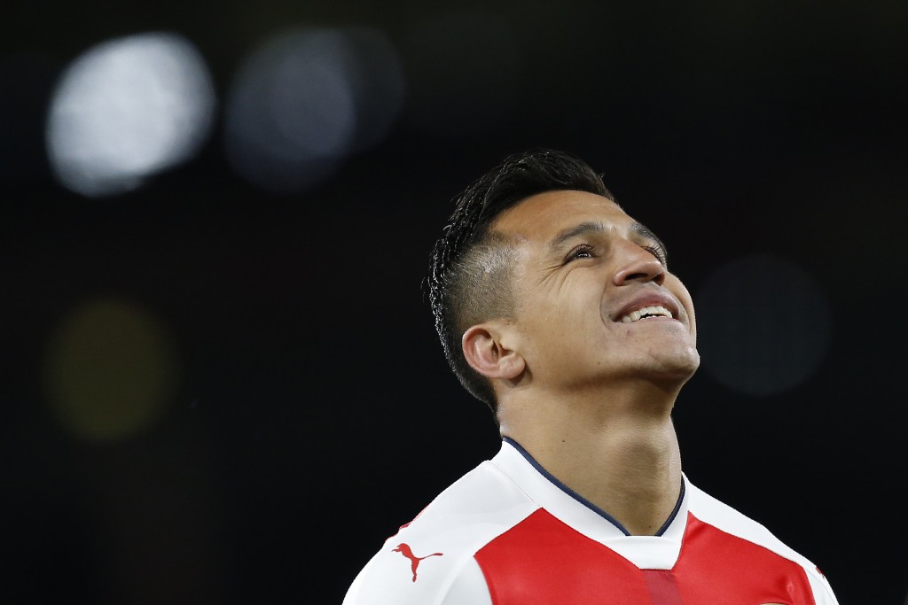 Arsenal's Chilean striker Alexis Sanchez reacts during the English Premier League football match between Arsenal and West Ham United at the Emirates Stadium in London on April 5, 2017. Arsenal won the match 3-0. / AFP PHOTO / Ian KINGTON / RESTRICTED TO EDITORIAL USE. No use with unauthorized audio, video, data, fixture lists, club/league logos or 'live' services. Online in-match use limited to 75 images, no video emulation. No use in betting, games or single club/league/player publications. / (Photo credit should read IAN KINGTON/AFP/Getty Images)