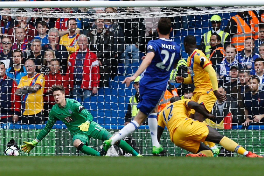 Crystal Palace's Welsh goalkeeper Wayne Hennessey (L) prpares to save from Chelsea's Serbian midfielder Nemanja Matic during the English Premier League football match between Chelsea and Crystal Palace at Stamford Bridge in London on April 1, 2017. / AFP PHOTO / Ian KINGTON / RESTRICTED TO EDITORIAL USE. No use with unauthorized audio, video, data, fixture lists, club/league logos or 'live' services. Online in-match use limited to 75 images, no video emulation. No use in betting, games or single club/league/player publications. / (Photo credit should read IAN KINGTON/AFP/Getty Images)