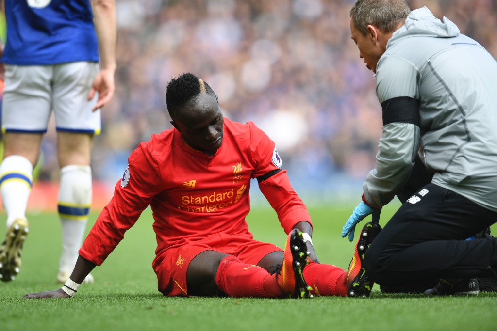 Liverpool's Senegalese midfielder Sadio Mane reacts as he receives medical attention after picking up an injury during the English Premier League football match between Liverpool and Everton at Anfield in Liverpool, north west England on April 1, 2017. / AFP PHOTO / Paul ELLIS / RESTRICTED TO EDITORIAL USE. No use with unauthorized audio, video, data, fixture lists, club/league logos or 'live' services. Online in-match use limited to 75 images, no video emulation. No use in betting, games or single club/league/player publications. / (Photo credit should read PAUL ELLIS/AFP/Getty Images)