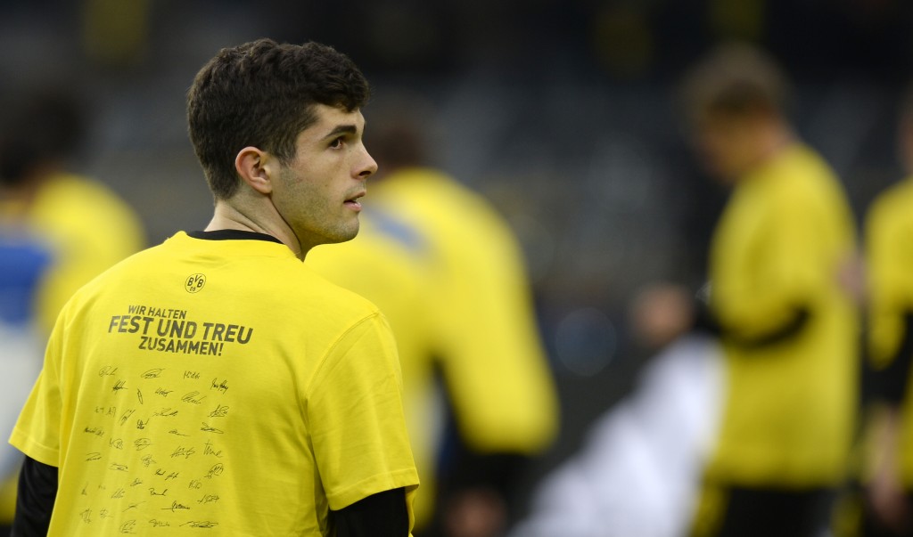 Dortmund's US midfielder Christian Pulisic wears a shirt reading "we stick together closely and loyally" during the warm up prior to the UEFA Champions League 1st leg quarter-final football match BVB Borussia Dortmund v Monaco in Dortmund, western Germany on April 12, 2017. The match had been postponed after three explosions hit German football team Borussia Dortmund's bus late on April 11, 2017 ahead of a Champions League home game. / AFP PHOTO / Sascha Schuermann (Photo credit should read SASCHA SCHUERMANN/AFP/Getty Images)