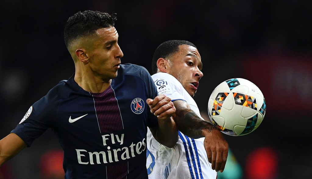 Paris Saint-Germain's Brazilian defender Marquinhos (L) and Lyon's Dutch forward Memphis Depay eye the ball during the French L1 football match Paris Saint-Germain (PSG) vs Olympique Lyonnais (OL) at the Parc des Princes stadium in Paris on March 19, 2017. / AFP PHOTO / FRANCK FIFE (Photo credit should read FRANCK FIFE/AFP/Getty Images)