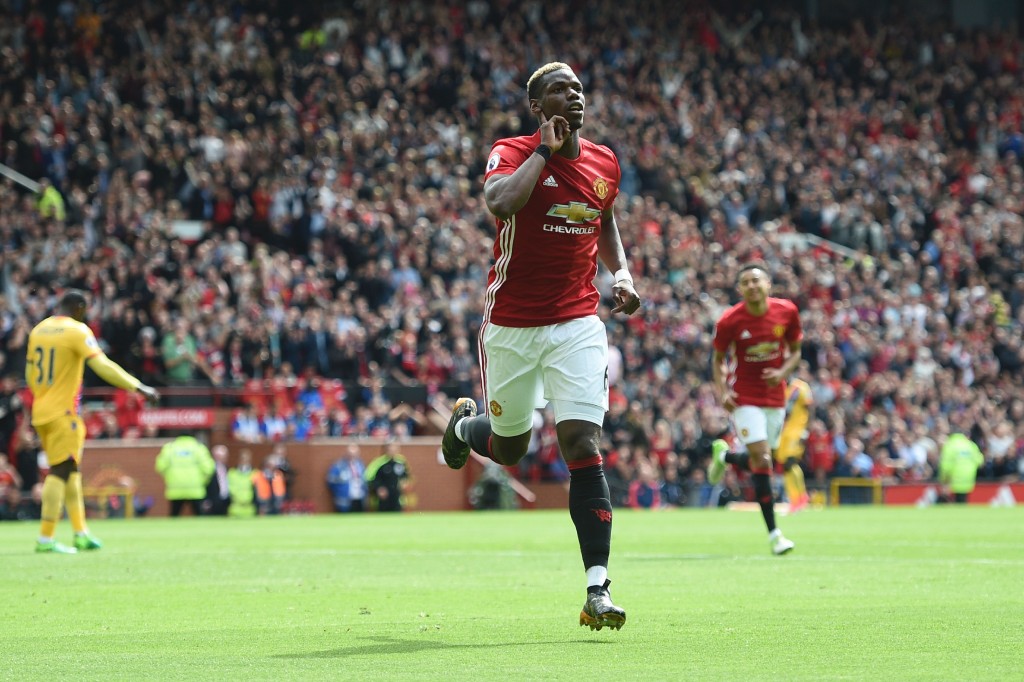 Manchester United's French midfielder Paul Pogba celebrates scoring their second goal during the English Premier League football match between Manchester United and Cyrstal Palace at Old Trafford in Manchester, north west England, on May 21, 2017. / AFP PHOTO / Oli SCARFF / RESTRICTED TO EDITORIAL USE. No use with unauthorized audio, video, data, fixture lists, club/league logos or 'live' services. Online in-match use limited to 75 images, no video emulation. No use in betting, games or single club/league/player publications. / (Photo credit should read OLI SCARFF/AFP/Getty Images)