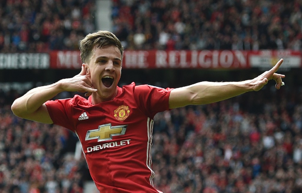 Manchester United's English midfielder Josh Harrop celebrates scoring thei opening goal during the English Premier League football match between Manchester United and Cyrstal Palace at Old Trafford in Manchester, north west England, on May 21, 2017. / AFP PHOTO / Oli SCARFF / RESTRICTED TO EDITORIAL USE. No use with unauthorized audio, video, data, fixture lists, club/league logos or 'live' services. Online in-match use limited to 75 images, no video emulation. No use in betting, games or single club/league/player publications. / (Photo credit should read OLI SCARFF/AFP/Getty Images)