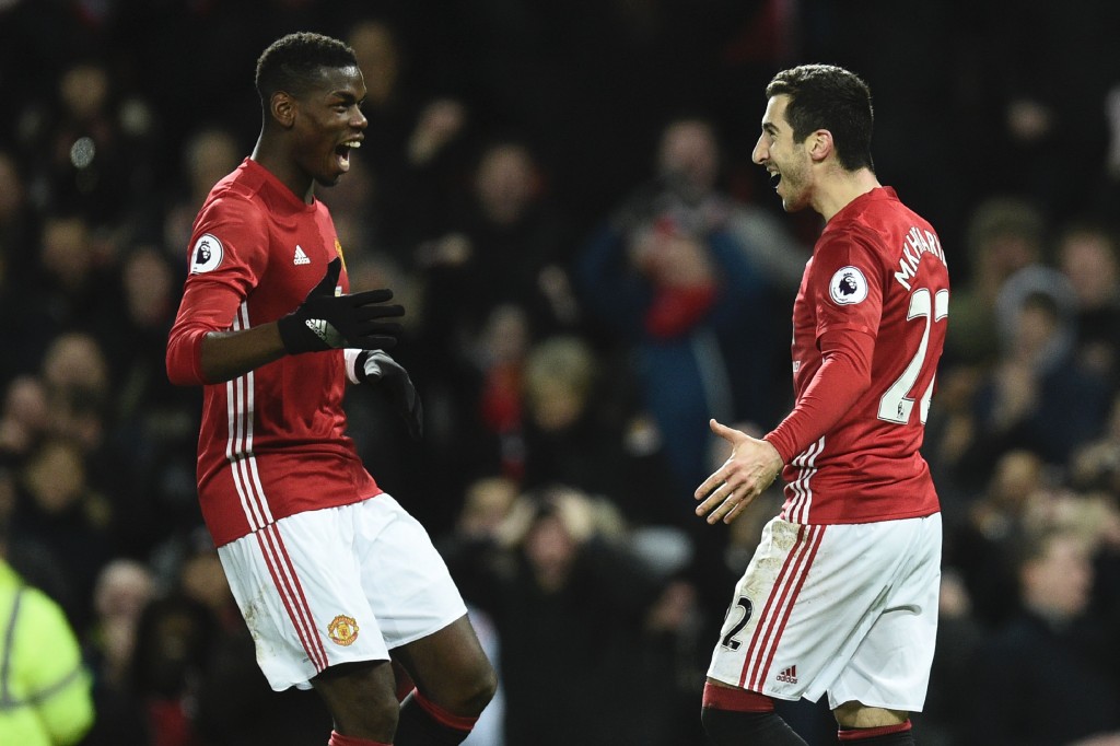 Manchester United's Armenian midfielder Henrikh Mkhitaryan (R) celebrates scoring their third goal with Manchester United's French midfielder Paul Pogba (L) during the English Premier League football match between Manchester United and Sunderland at Old Trafford in Manchester, north west England, on December 26, 2016. / AFP / Oli SCARFF / RESTRICTED TO EDITORIAL USE. No use with unauthorized audio, video, data, fixture lists, club/league logos or 'live' services. Online in-match use limited to 75 images, no video emulation. No use in betting, games or single club/league/player publications. / (Photo credit should read OLI SCARFF/AFP/Getty Images)