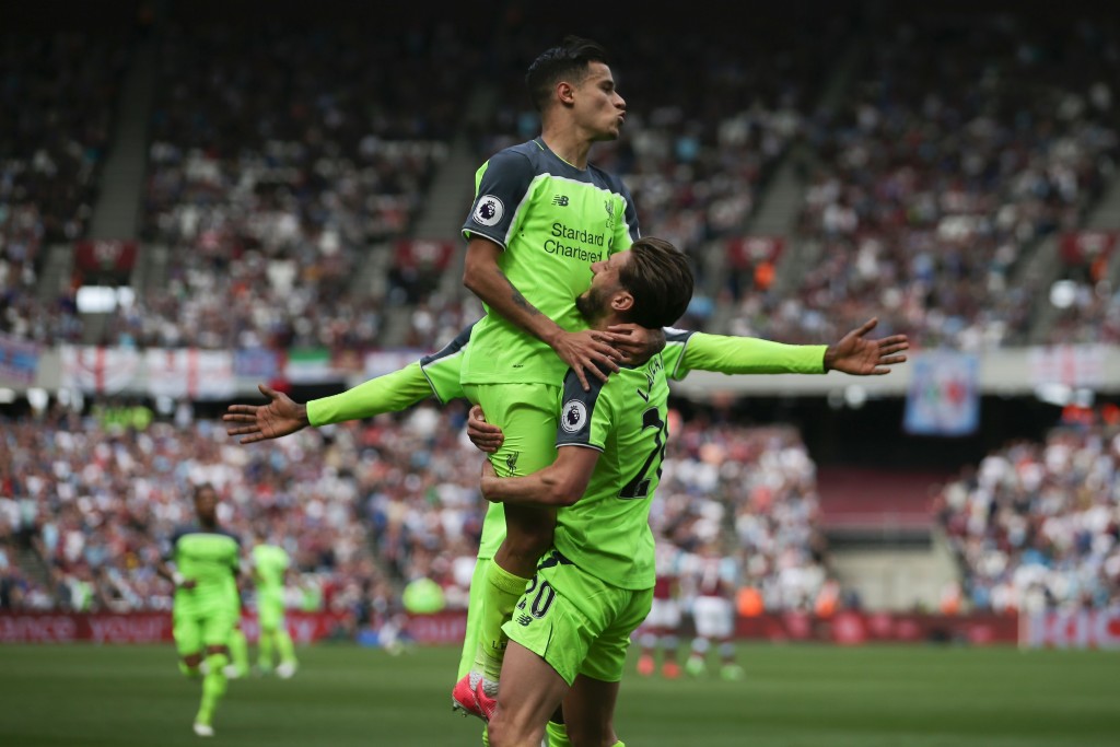 Liverpool's Brazilian midfielder Philippe Coutinho (L) and Liverpool's English midfielder Adam Lallana celebrate their third goal during the English Premier League football match between West Ham United and Liverpool at The London Stadium, in east London on May 14, 2017. / AFP PHOTO / Daniel LEAL-OLIVAS / RESTRICTED TO EDITORIAL USE. No use with unauthorized audio, video, data, fixture lists, club/league logos or 'live' services. Online in-match use limited to 75 images, no video emulation. No use in betting, games or single club/league/player publications. / (Photo credit should read DANIEL LEAL-OLIVAS/AFP/Getty Images)