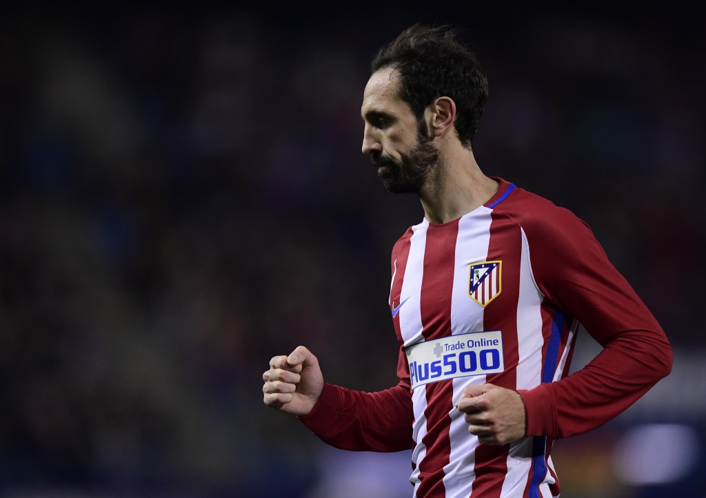 Atletico Madrid's defender Juanfran celebrates their third goal during the Spanish Copa del Rey (King's Cup) round of 32 second leg football match Club Atletico de Madrid vs CD Guijuelo at the Vicente Calderon stadium in Madrid on December 20, 2016. / AFP / JAVIER SORIANO (Photo credit should read JAVIER SORIANO/AFP/Getty Images)