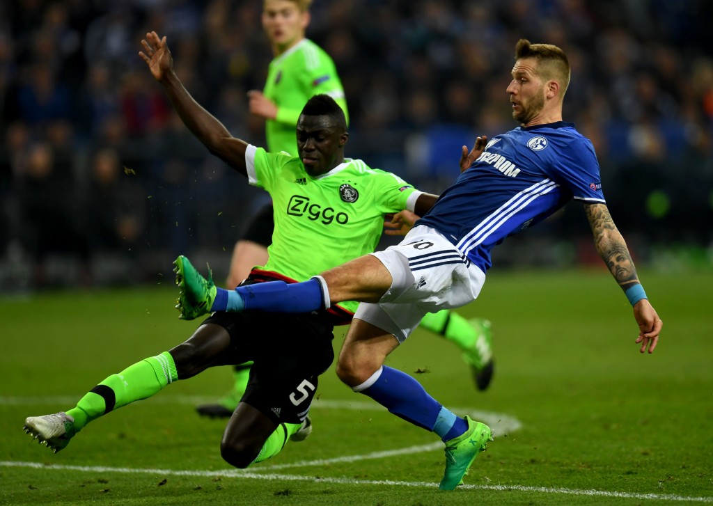 Ajax Amsterdam's defender Davinson Sanchez and Schalke's Austrian striker Guido Burgstaller vie for the ball during the UEFA Europa League 2nd-leg quarter-final football match between Schalke 04 and Ajax Amsterdam in Gelsenkirchen, western Germany on April 20, 2017. / AFP PHOTO / PATRIK STOLLARZ (Photo credit should read PATRIK STOLLARZ/AFP/Getty Images)