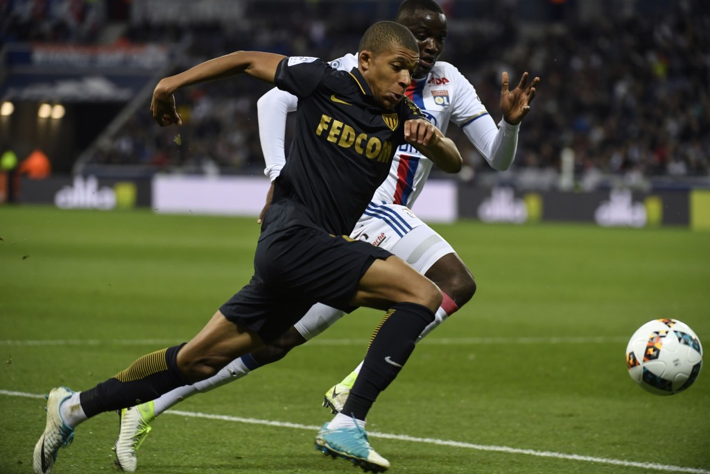 Monaco's French forward Kylian Mbappe Lottin (L) vies with Lyon's defender Mouctar Diakhaby (R) during the French L1 football match between Olympique Lyonnais and AS Monaco, on April 23, 2017 at Parc Olympique Lyonnais stadium in Decines-Charpieu near Lyon, southeastern France. / AFP PHOTO / PHILIPPE DESMAZES (Photo credit should read PHILIPPE DESMAZES/AFP/Getty Images)