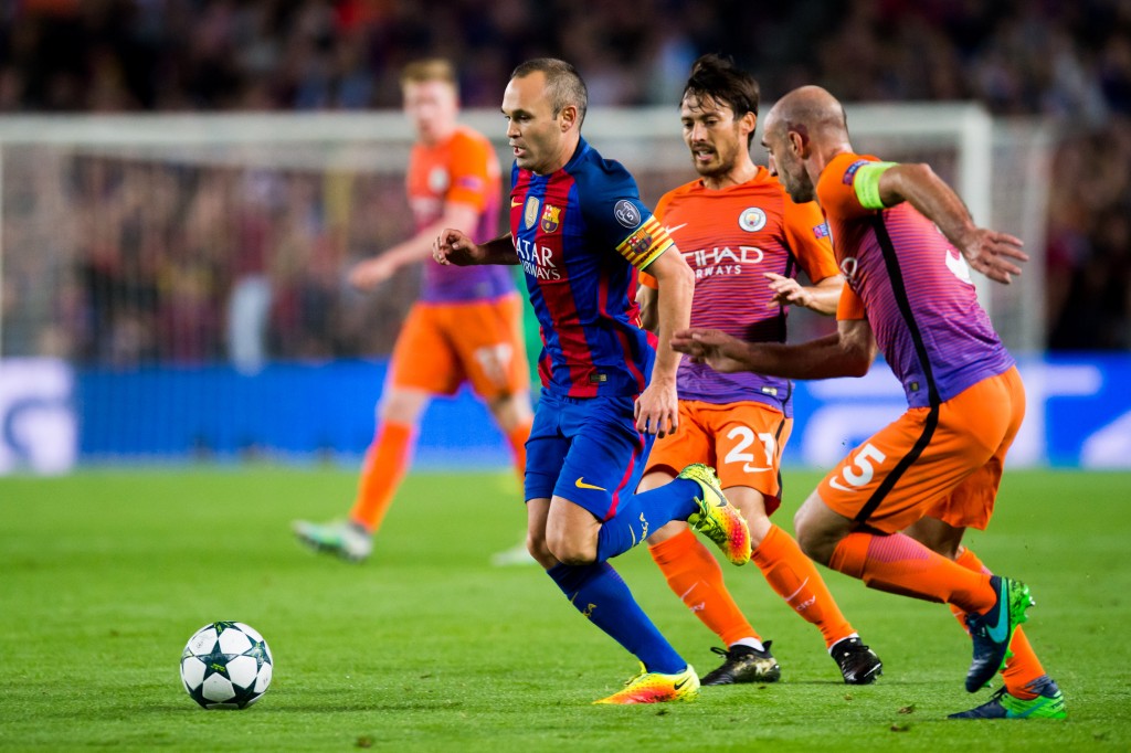 BARCELONA, SPAIN - OCTOBER 19: Andres Iniesta (L) of FC Barcelona runs with the ball next to David Silva (2nd R) and Pablo Zabaleta (R) of Manchester City FC during the UEFA Champions League group C match between FC Barcelona and Manchester City FC at Camp Nou on October 19, 2016 in Barcelona, Spain. (Photo by Alex Caparros/Getty Images)