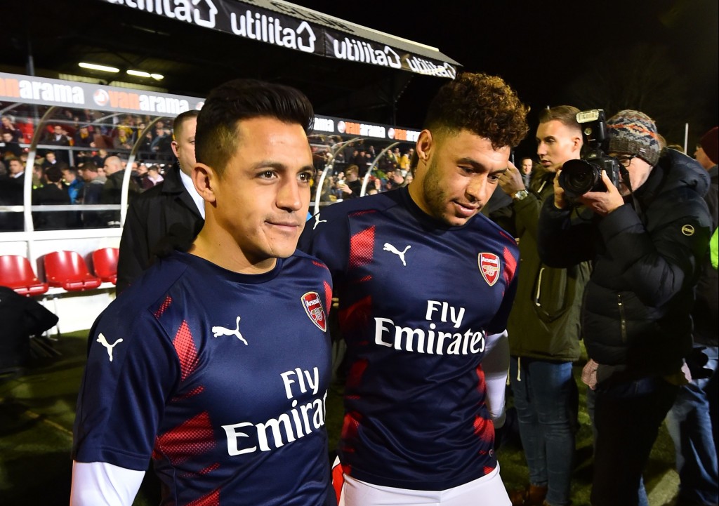 Arsenal's Chilean striker Alexis Sanchez (L0 and Arsenal's English midfielder Alex Oxlade-Chamberlain check the pitch ahead of the English FA Cup fifth round football match between Sutton United and Arsenal at the Borough Sports Ground, Gander Green Lane in south London on February 20, 2017. / AFP / Glyn KIRK / RESTRICTED TO EDITORIAL USE. No use with unauthorized audio, video, data, fixture lists, club/league logos or 'live' services. Online in-match use limited to 75 images, no video emulation. No use in betting, games or single club/league/player publications. / (Photo credit should read GLYN KIRK/AFP/Getty Images)