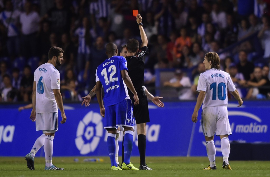 Real Madrid's defender Sergio Ramos is shown a red card by the referee during the Spanish league footbal match RC Deportivo de la Coruna vs Real Madrid CF at the Municipal de Riazor stadium in La Coruna on August 20, 2017. Real Madrid won 3-0. / AFP PHOTO / MIGUEL RIOPA (Photo credit should read MIGUEL RIOPA/AFP/Getty Images)