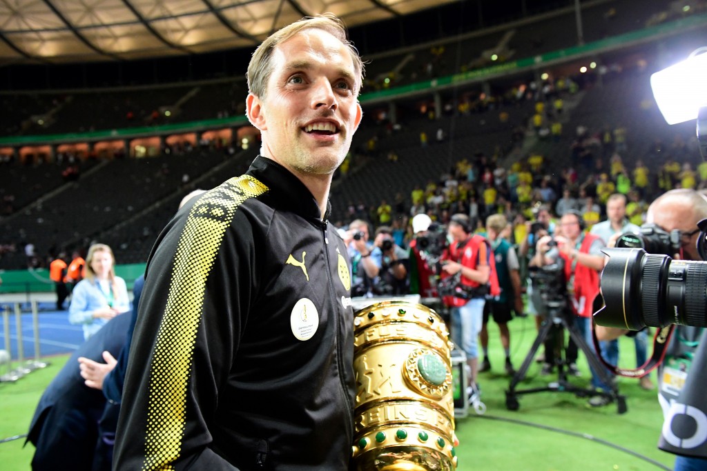 Dortmund's head coach Thomas Tuchel celebrates with the trophy after the German Cup (DFB Pokal) final football match Eintracht Frankfurt v BVB Borussia Dortmund at the Olympic stadium in Berlin on May 27, 2017. / AFP PHOTO / Tobias SCHWARZ / RESTRICTIONS: ACCORDING TO DFB RULES IMAGE SEQUENCES TO SIMULATE VIDEO IS NOT ALLOWED DURING MATCH TIME. MOBILE (MMS) USE IS NOT ALLOWED DURING AND FOR FURTHER TWO HOURS AFTER THE MATCH. == RESTRICTED TO EDITORIAL USE == FOR MORE INFORMATION CONTACT DFB DIRECTLY AT +49 69 67880 / (Photo credit should read TOBIAS SCHWARZ/AFP/Getty Images)