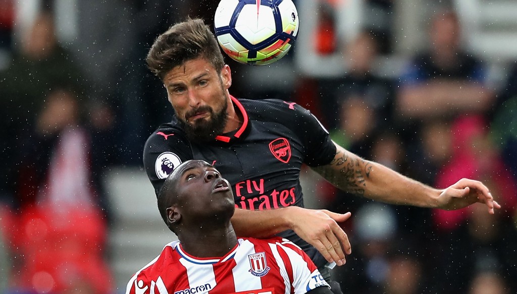 STOKE ON TRENT, ENGLAND - AUGUST 19: Kurt Zouma of Stoke City and Olivier Giroud of Arsenal battle for possession in the air during the Premier League match between Stoke City and Arsenal at Bet365 Stadium on August 19, 2017 in Stoke on Trent, England. (Photo by David Rogers/Getty Images)