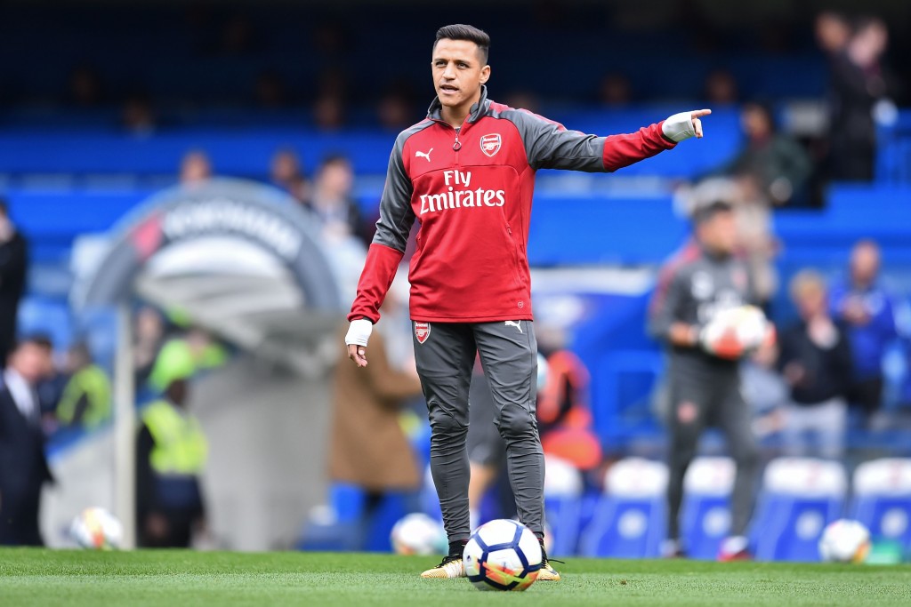 Arsenal's Chilean striker Alexis Sanchez warms up ahead of the English Premier League football match between Chelsea and Arsenal at Stamford Bridge in London on September 17, 2017. / AFP PHOTO / Glyn KIRK / RESTRICTED TO EDITORIAL USE. No use with unauthorized audio, video, data, fixture lists, club/league logos or 'live' services. Online in-match use limited to 75 images, no video emulation. No use in betting, games or single club/league/player publications. / (Photo credit should read GLYN KIRK/AFP/Getty Images)