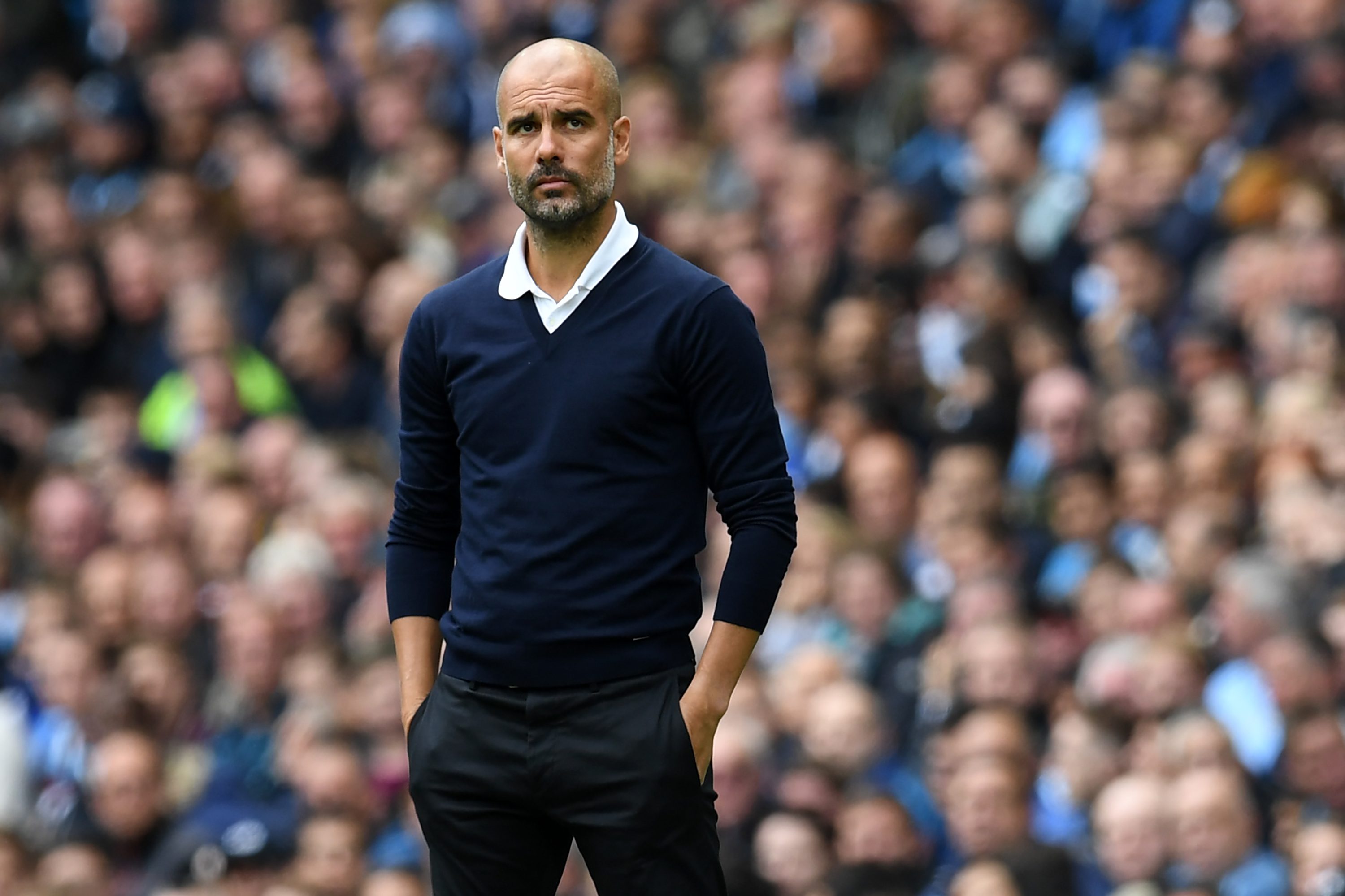 Manchester City's Spanish manager Pep Guardiola watches from the touchline during the English Premier League football match between Manchester City and Liverpool at the Etihad Stadium in Manchester, north west England, on September 9, 2017. / AFP PHOTO / Paul ELLIS / RESTRICTED TO EDITORIAL USE. No use with unauthorized audio, video, data, fixture lists, club/league logos or 'live' services. Online in-match use limited to 75 images, no video emulation. No use in betting, games or single club/league/player publications. / (Photo credit should read PAUL ELLIS/AFP/Getty Images)